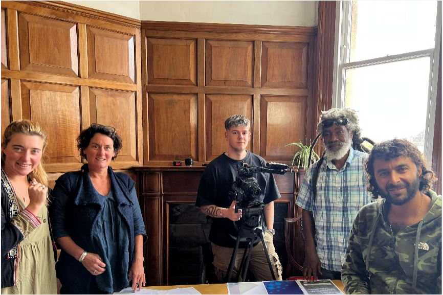 Meriwether Lewis (Production Manager), Clare Torrible, Joshua Steer (Camera Assistant), Ras Judah Adunbi, Bashart Malik (Director), standing around a table with papers